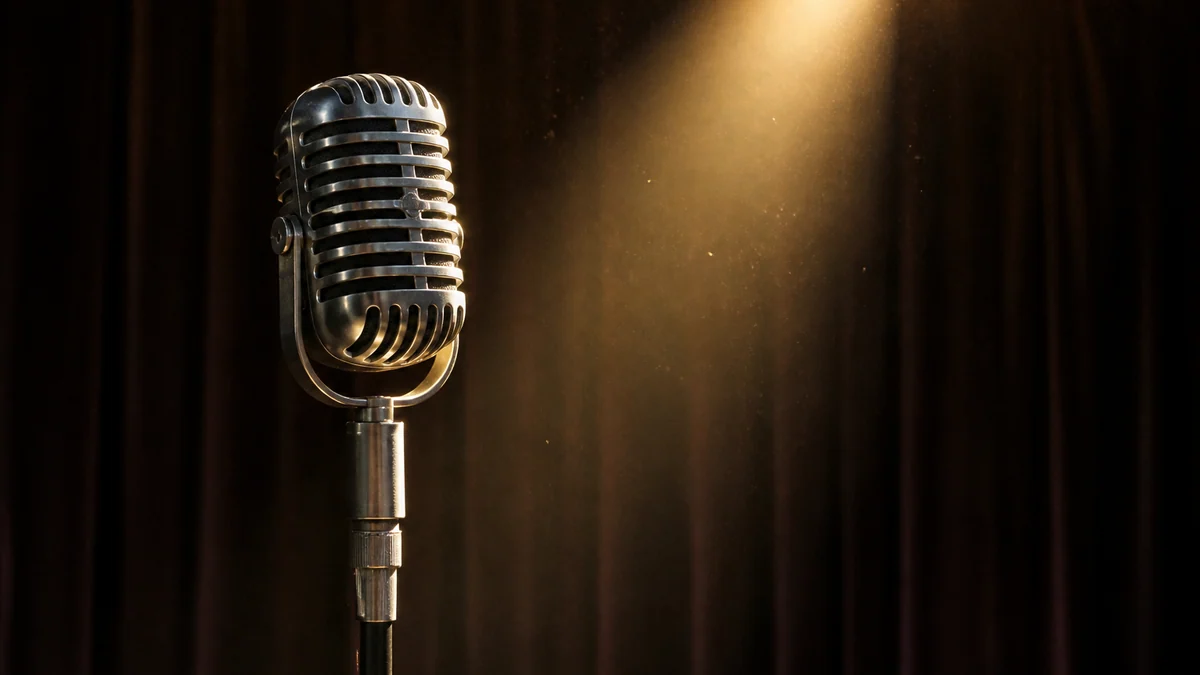 A vintage microphone under a single warm spotlight before a heavy curtain.